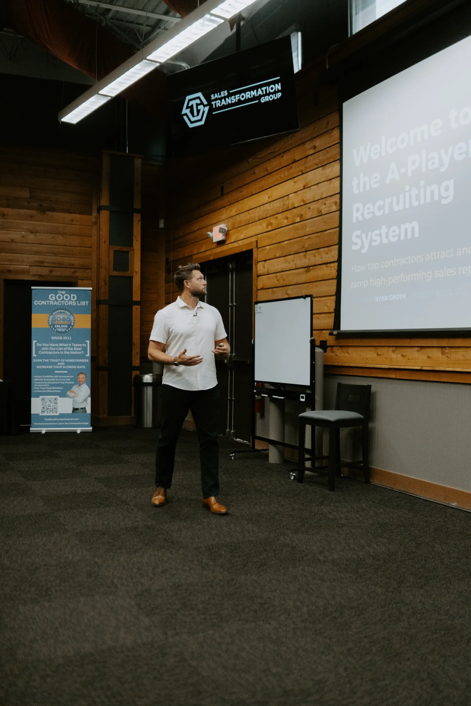STG facilitator presenting beside event signage at a contractor sales workshop