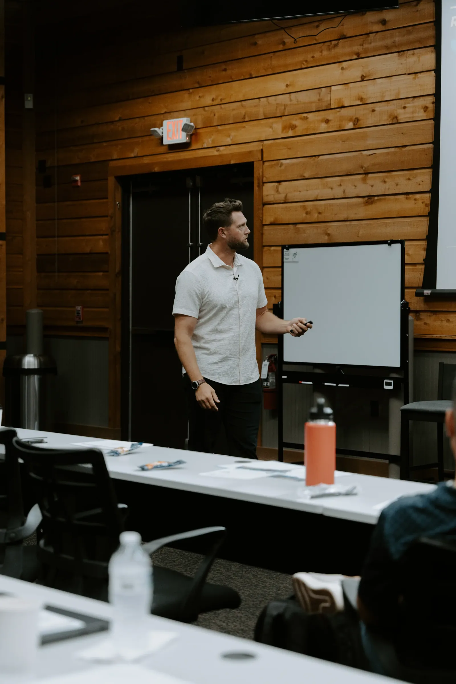 STG facilitator teaching at a whiteboard during a contractor sales workshop